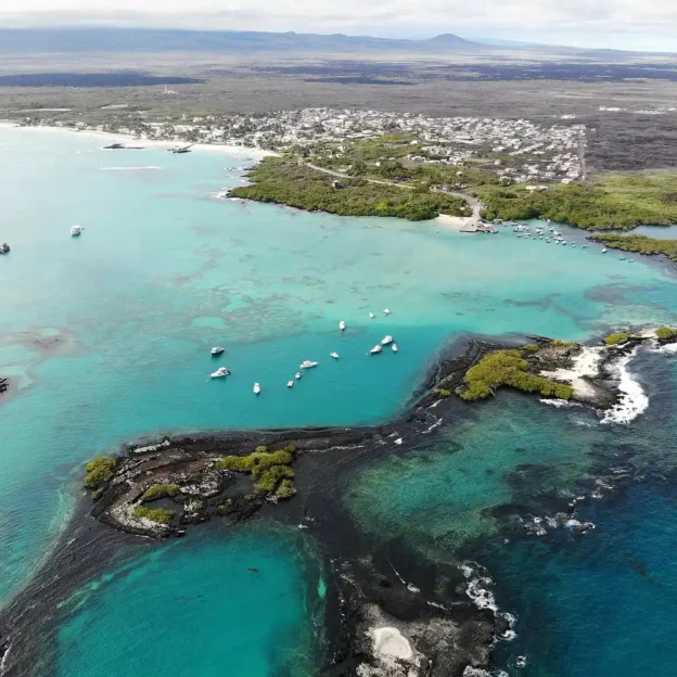 Aerial view of Tintoreras Islet with turquoise waters and lava trails, Galapagos