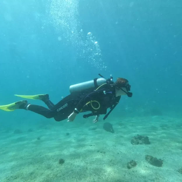 Diver floating on the seabed in the waters of Mosquera