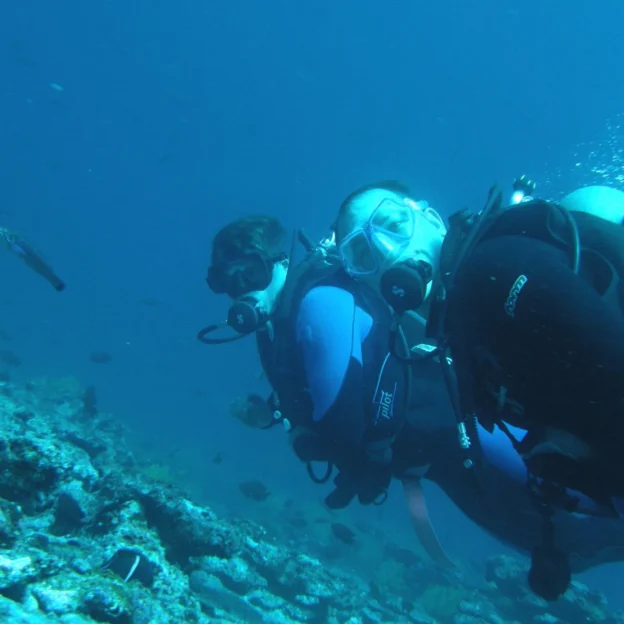 Group of divers descending to the seafloor in North Seymour