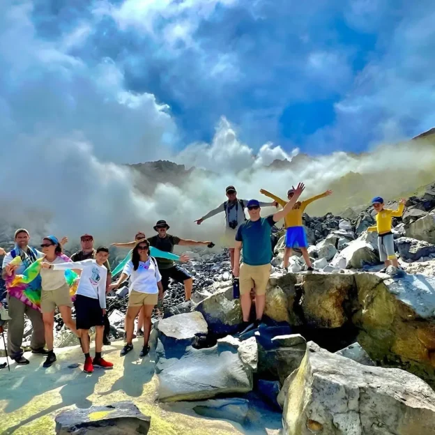 Group of tourists posing with a guide at the Sulfur Mines