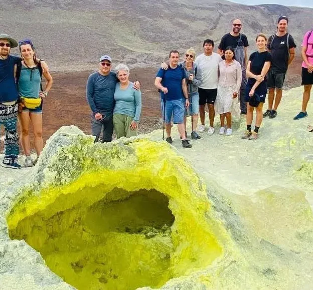 Tourists exploring the yellow volcanic formations of the Sulfur Mines